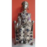 A large silver Medieval style reliquary in the form of a figure seated on a throne, inlaid with