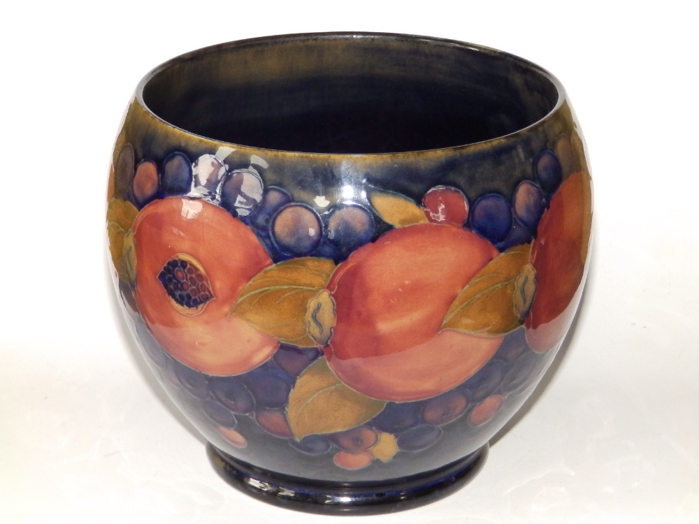 A Moorcroft Pomegranate pattern cache pot, impressed 'Moorcroft, Made in England' and blue painted