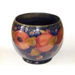 A Moorcroft Pomegranate pattern cache pot, impressed 'Moorcroft, Made in England' and blue painted