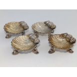 A set of four silver shell salts, on triple dolphin feet - HA, Birmingham 1862, 2.6" across. (4)