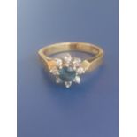 A modern sapphire & diamond cluster ring on '18ct' yellow shank. Finger size O.