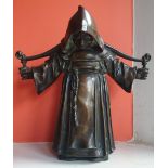An antique bronze figure study of a monk carrying a yoke over his shoulders, 10" high.
