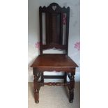 An early Georgian oak panel seated chair, having pierced heart motif to cresting rail, 44" high.