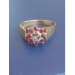 A modern illusion set ruby & diamond cluster ring in 18ct gold. Finger size M.