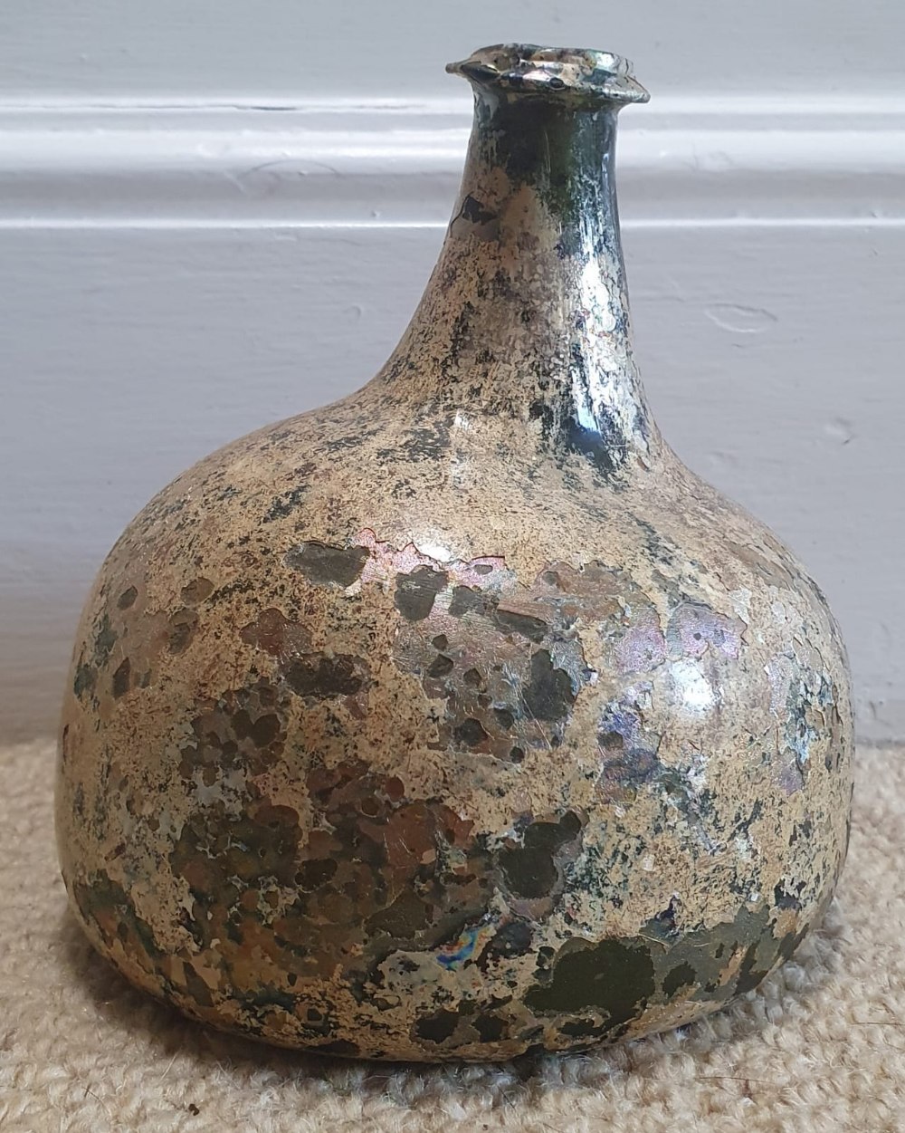 An English onion shaped glass wine bottle, circa 1700, 6" high.