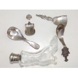 A moulded glass shoe-shaped scent bottle with London silver lid and four white metal/EP caddy spoons