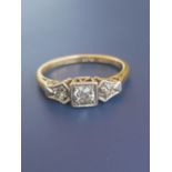 A three stone diamond illusion set 18ct gold ring. Finger size J.