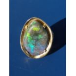 An 18ct gold ring set with a large free-form black opal. Finger size K/L.