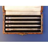 A cased set of four 'Sterling' silver bridge pencils - enamel rubbed.
