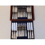 A mahogany canteen of 12 Victorian mother-of-pearl handled EP tea knives & forks - one handle