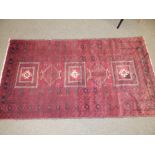 A Baluchi rug, the centre occupied by three rectangles and two octagons with small animal motifs,