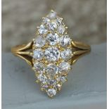 A marquise pave set diamond ring in '18ct' gold. Finger size P.