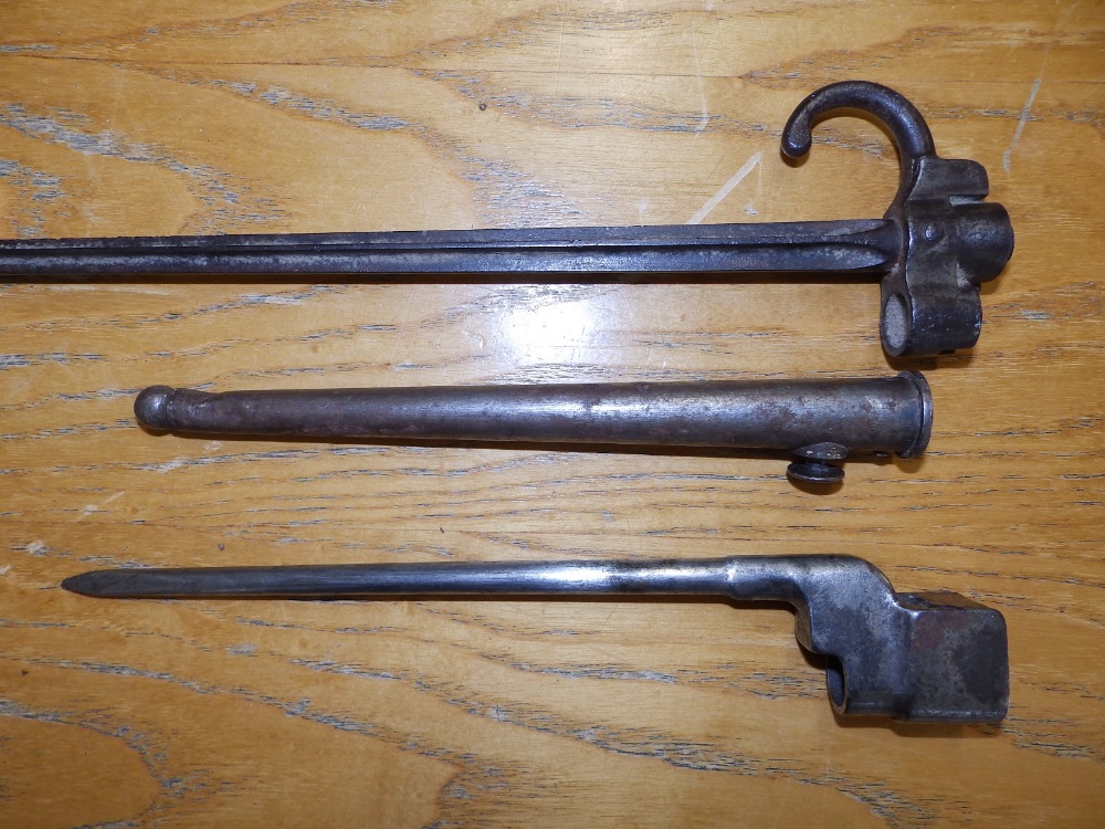A French bayonet in scabbard - 'RP 96170', 21.5" overall, and an Enfield type bayonet. (2)