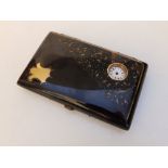 A tortoiseshell aide memoire/card case inset with a watch to the gold pique work cover- (hands