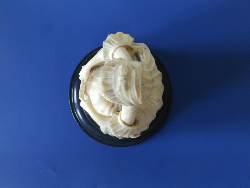 An antique carved ivory female figure, depicting a young woman in 18thC costume, holding a fan in - Image 5 of 6