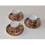 Three Royal Crown Derby porcelain Japan pattern coffee cans and saucers - pattern number 2451. (6)