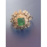 A modern emerald & diamond '750' cluster ring. Finger size P - emerald chipped.