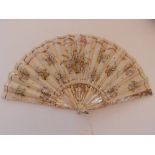 A 19thC mother-of pearl fan, the silk leaf decorated with embroidery and sequins, 15.5" across, in