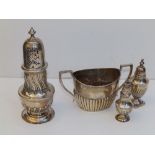 A silver sugar caster - HS, Sheffield 1891, 6.75" high, A Birmingham sugar bowl and two pepperettes.