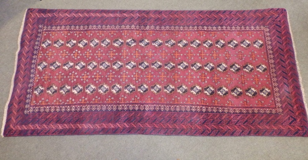 A Bokhara style Baluchi rug, woven with three rows of octagons, 90" x 41".