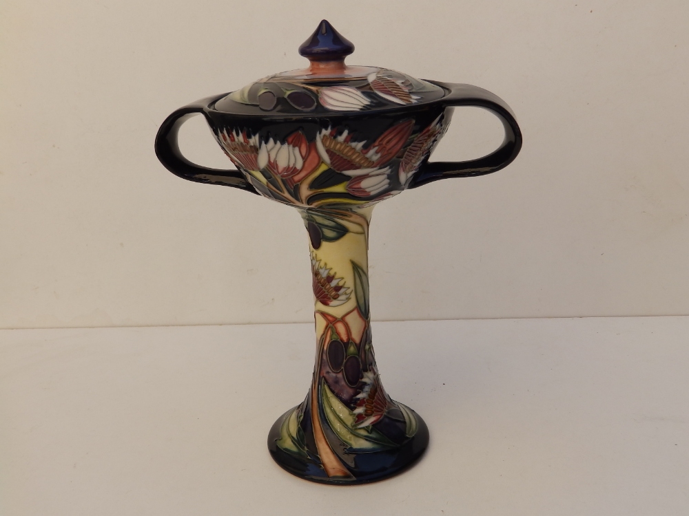 A boxed Moorcroft Collectors'Club two-handled bonbonierre with cover in 'Symphony' pattern by Emma