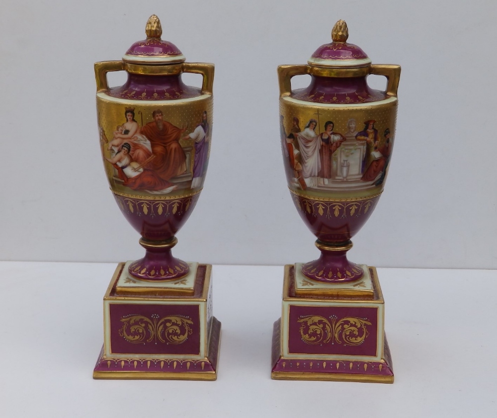 A pair of Vienna porcelain two-handled vases of urn shape on square pedestal bases, the sides