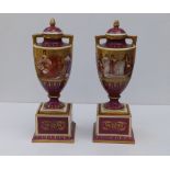 A pair of Vienna porcelain two-handled vases of urn shape on square pedestal bases, the sides