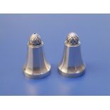 A small pair of Georg Jensen silver salt & pepper pots, 1.75" high. (2)