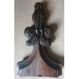 An early carved oak pew bench terminal of fleur-de-lys form, 18.25" high.