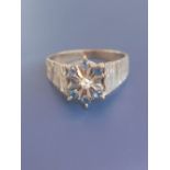 A modern sapphire & diamond illusion set flower cluster ring in 18ct white gold. Finger size L.
