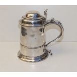 A George II silver lidded tankard with domed cover, scrolled thumbpiece , the tapering cylinder body