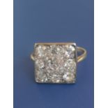 A diamond dress ring having a square pave setting on yellow metal shank. Finger size L.