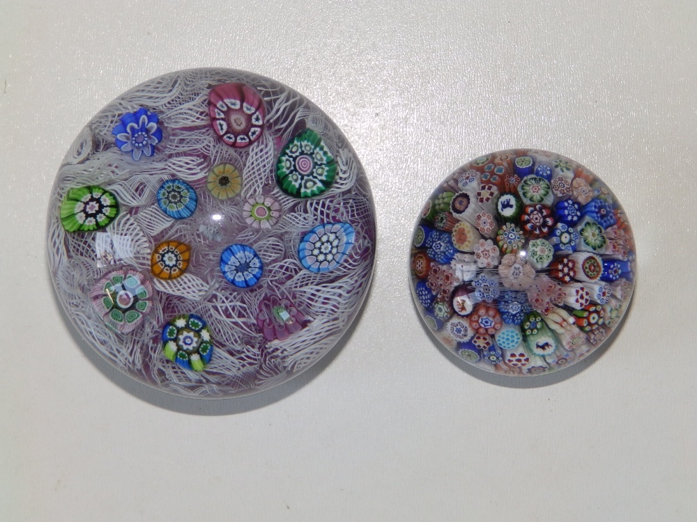 A scrambled cane paperweight, 2.75" diameter and a small millefiori paperweight with animal