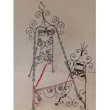 Two wrought iron easel picture stands, the larger 17" high.