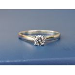 A modern diamond solitaire, the brilliant cut stone weighing approximately 0.25 carat, four-claw set