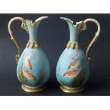 A small pair of Royal Worcester porcelain ewers painted by Harry Davies with goldfish - 2259, puce