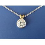 A modern diamond solitaire pendant, the collet set brilliant weighing approximately 0.70 carat in