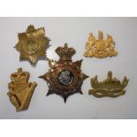 Four various pouch badges and a Victorian helmet plate. (5)