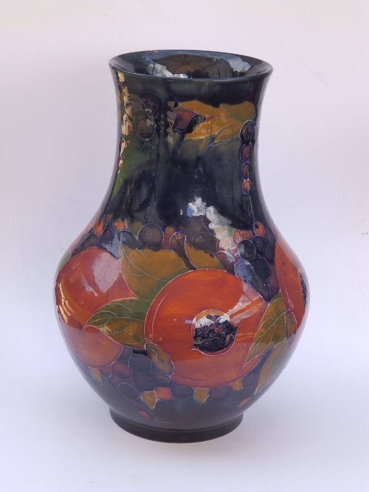 A Moorcroft Pomegranate pattern vase, green painted signature and impressed 'Burslem England M4', 9"