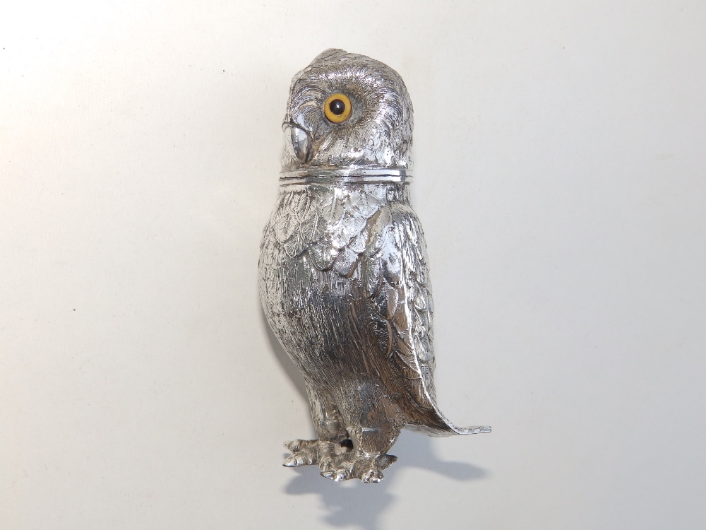 A silver plated caster/pounce pot modelled as an owl with glass eyes, 4" high.