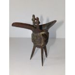 A Chinese bronze Archaic style tripod pouring vessel, 7" high.