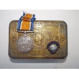 A WWI Christmas ration tin with War Medal awarded to Rev. H.H. Sanders.