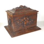 A Black Forest carved wood cigar box, having hinged folding cover, five internal trays, 13"