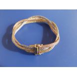 A three colour 14K 585 bracelet of braided design, 6.8".