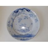 An 18thC English blue & white delft charger, the chinoiserie decoration showing three cranes and