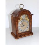 A small early 20thC walnut bracket clock by Charles Frodsham 'Clockmaker to H M George VI', arched