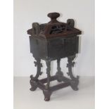 An antique Chinese archaistic bronze rectangular censer, on four scroll cast feet, pierced wooden