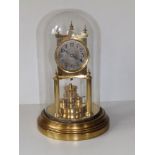 A domed brass anniversary clock by Gustav Becker, with revolving platform, 11.5" overall height.