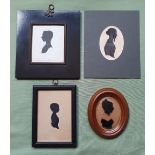 Four framed silhouette portraits.