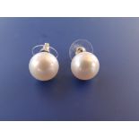 A pair of large cultured pearl earrings, each pearl approximately 11.5mm diameter. (2)